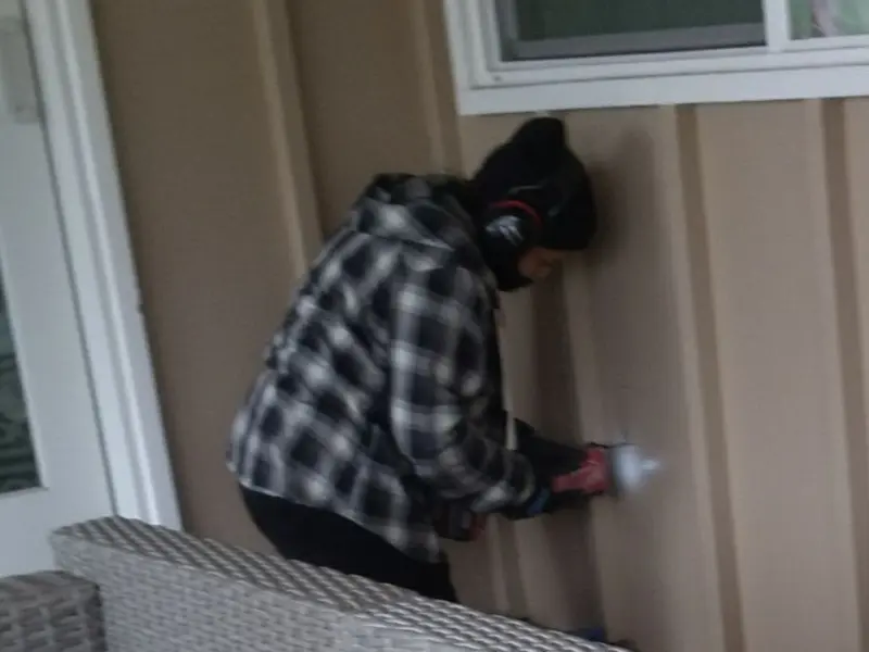 Professional electrician installing an exterior outlet in Pavilion